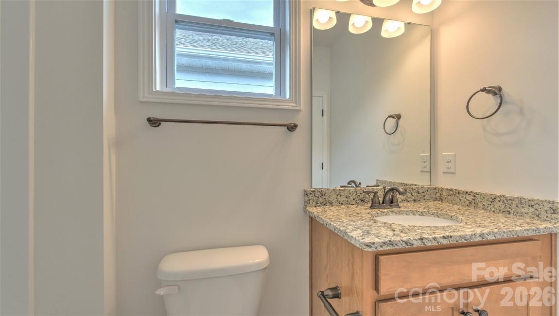 649 River Btm Road Fletcher, NC 28732 - Photo 17 of 40 a bathroom with a granite countertop sink and a mirror