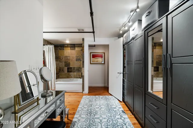 a view of a terrace with lawn chairs and iron fence