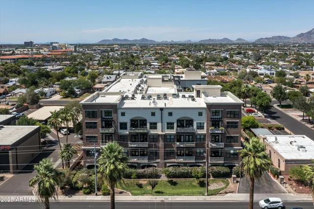 a outdoor space with patio couches a fireplace and a dining table