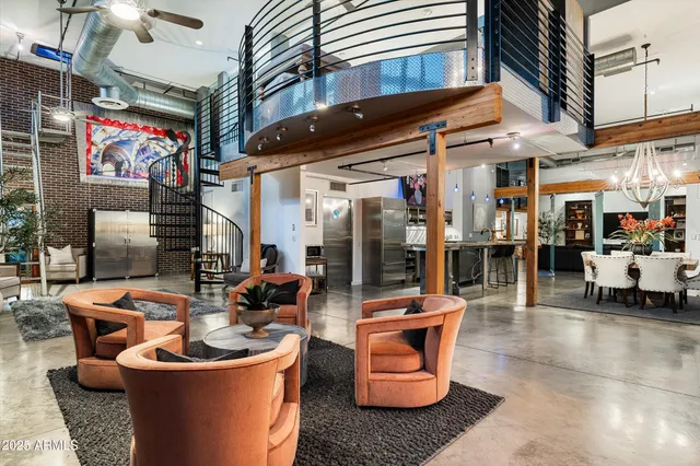 a view of a dining room with furniture a chandelier and wooden floor