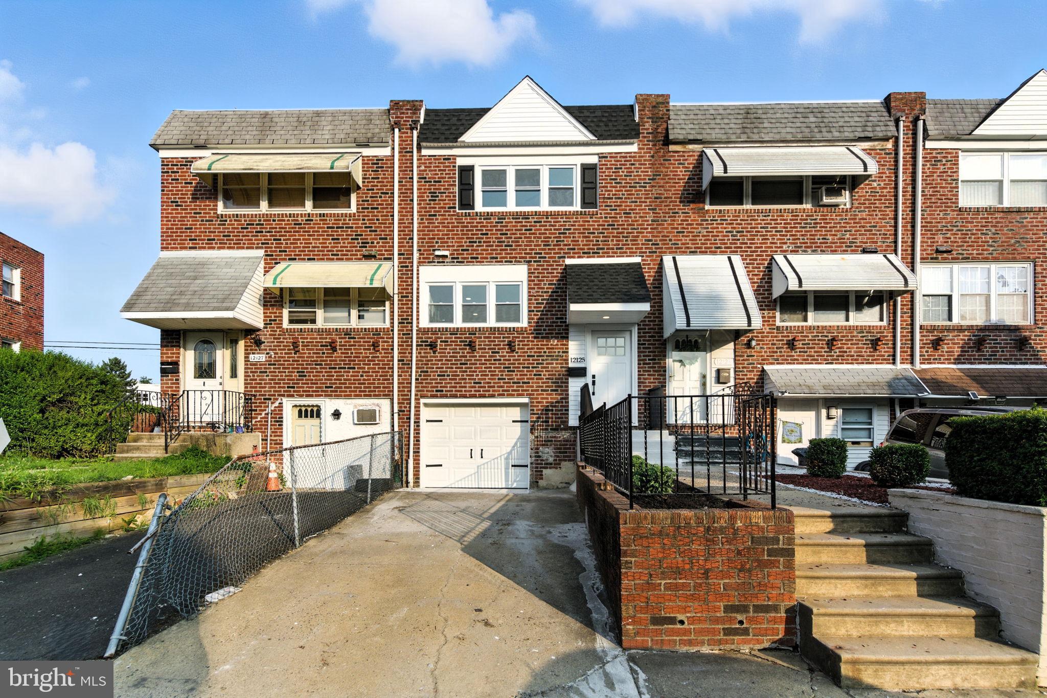 12125 Barbary Road Philadelphia, PA 19154 - Photo 1 of 26 a front view of a house with a yard