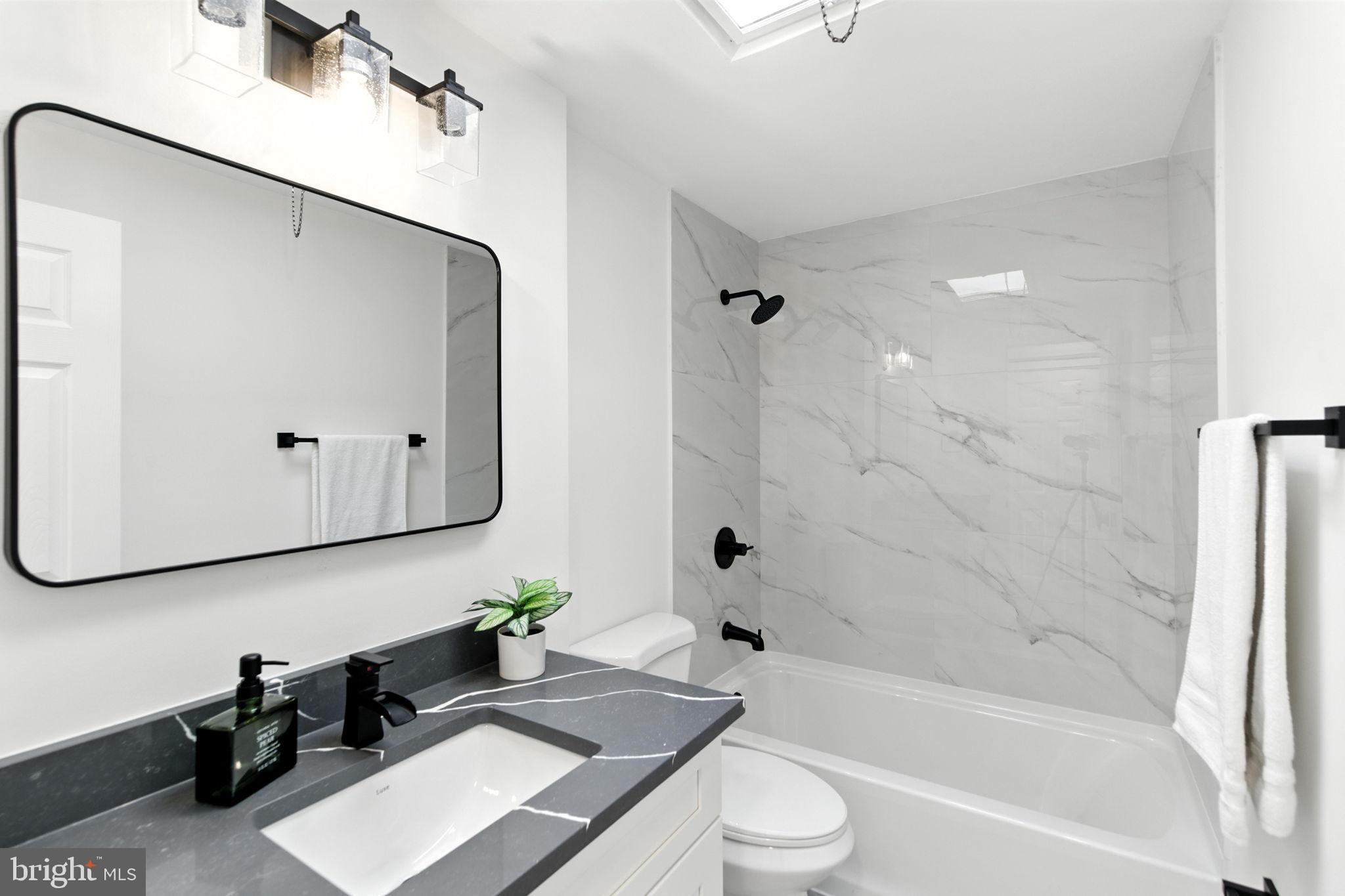 12125 Barbary Road Philadelphia, PA 19154 - Photo 12 of 26 a bathroom with a bathtub a sink a toilet and a mirror