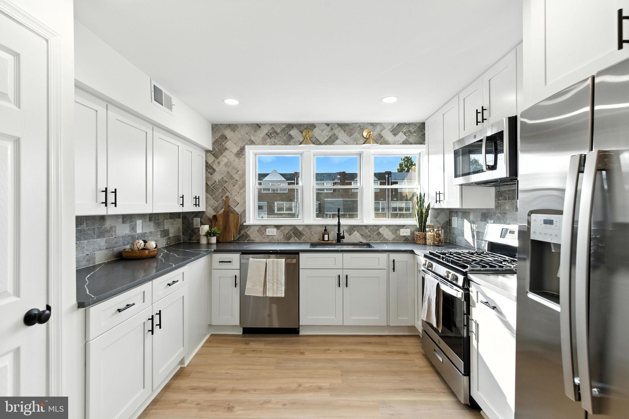 12125 Barbary Road Philadelphia, PA 19154 - Photo 7 of 26 a kitchen with stainless steel appliances granite countertop a sink stove and refrigerator