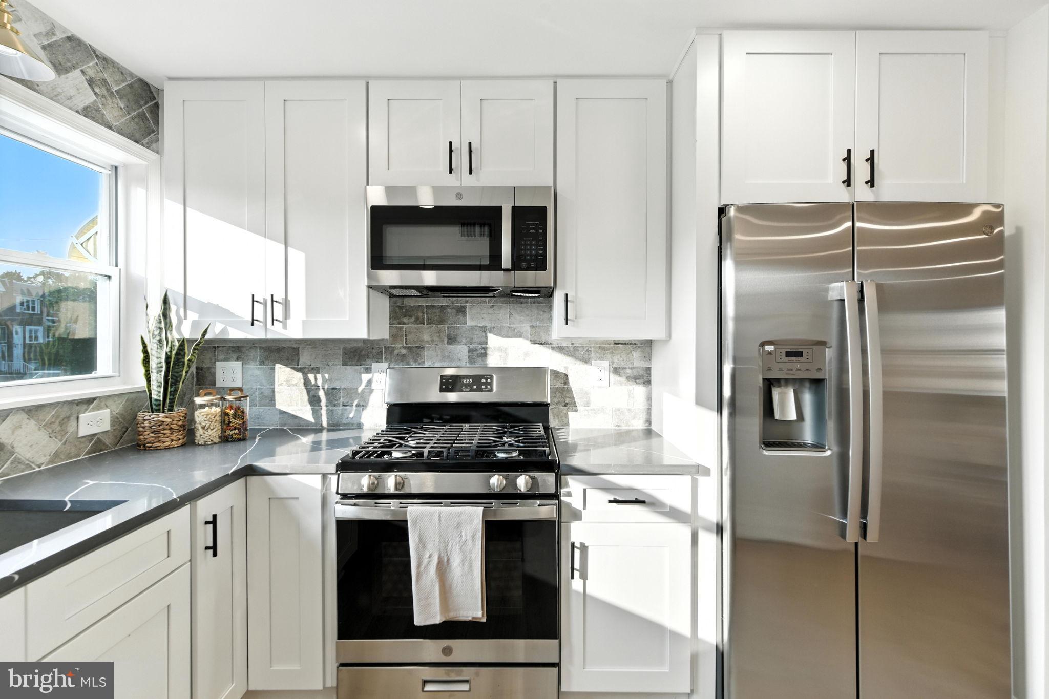 12125 Barbary Road Philadelphia, PA 19154 - Photo 8 of 26 a kitchen with stainless steel appliances a refrigerator stove and microwave