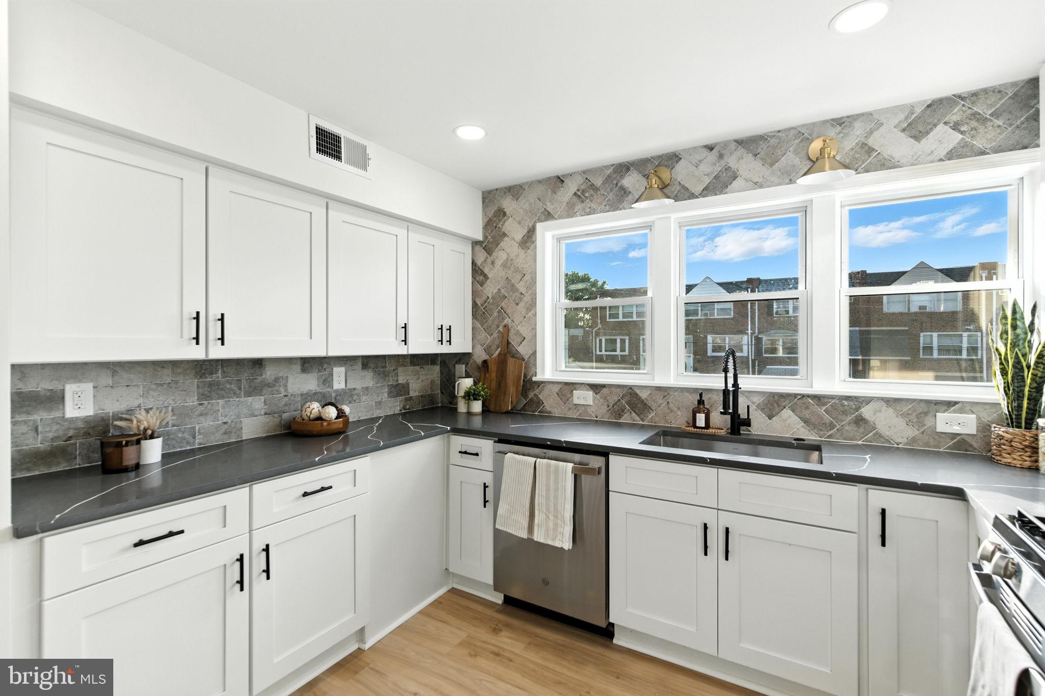 12125 Barbary Road Philadelphia, PA 19154 - Photo 9 of 26 a kitchen with granite countertop stainless steel appliances a sink and cabinets