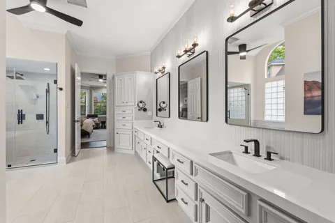 a spacious bathroom with a double vanity sink mirror and shower