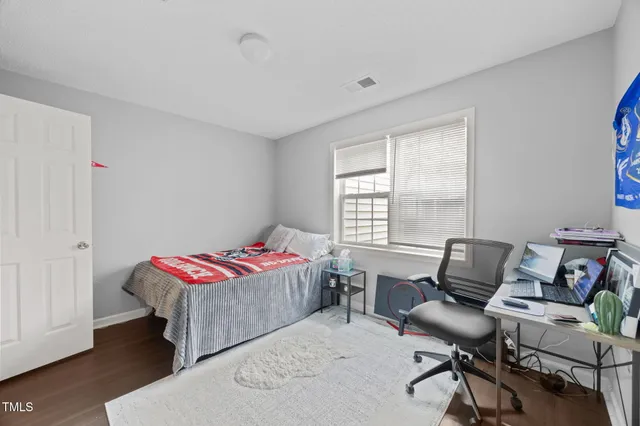 a bedroom with a workspace