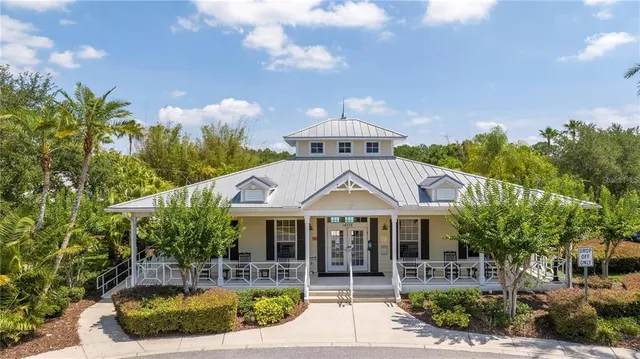 a view of swimming pool with outdoor seating patio and green space