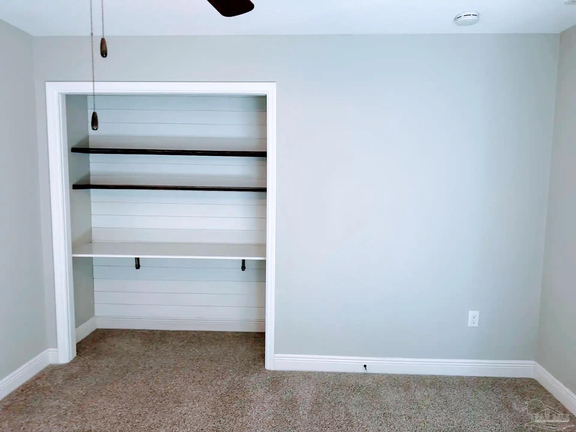 1938 Commodore Drive Navarre, FL 32566 - Photo 15 of 24 a view of an empty walk in closet