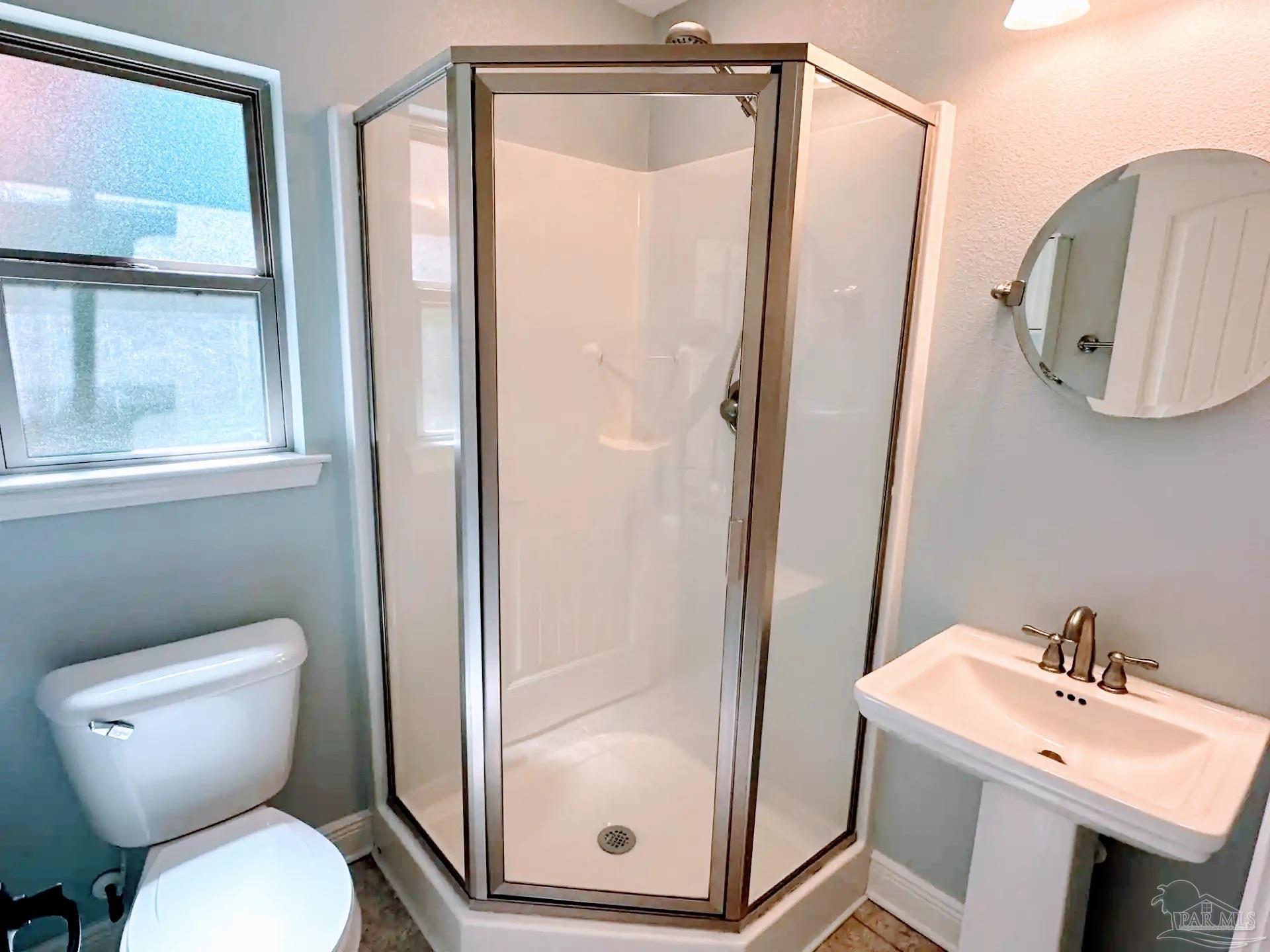 1938 Commodore Drive Navarre, FL 32566 - Photo 16 of 24 a bathroom with a toilet a sink and a mirror