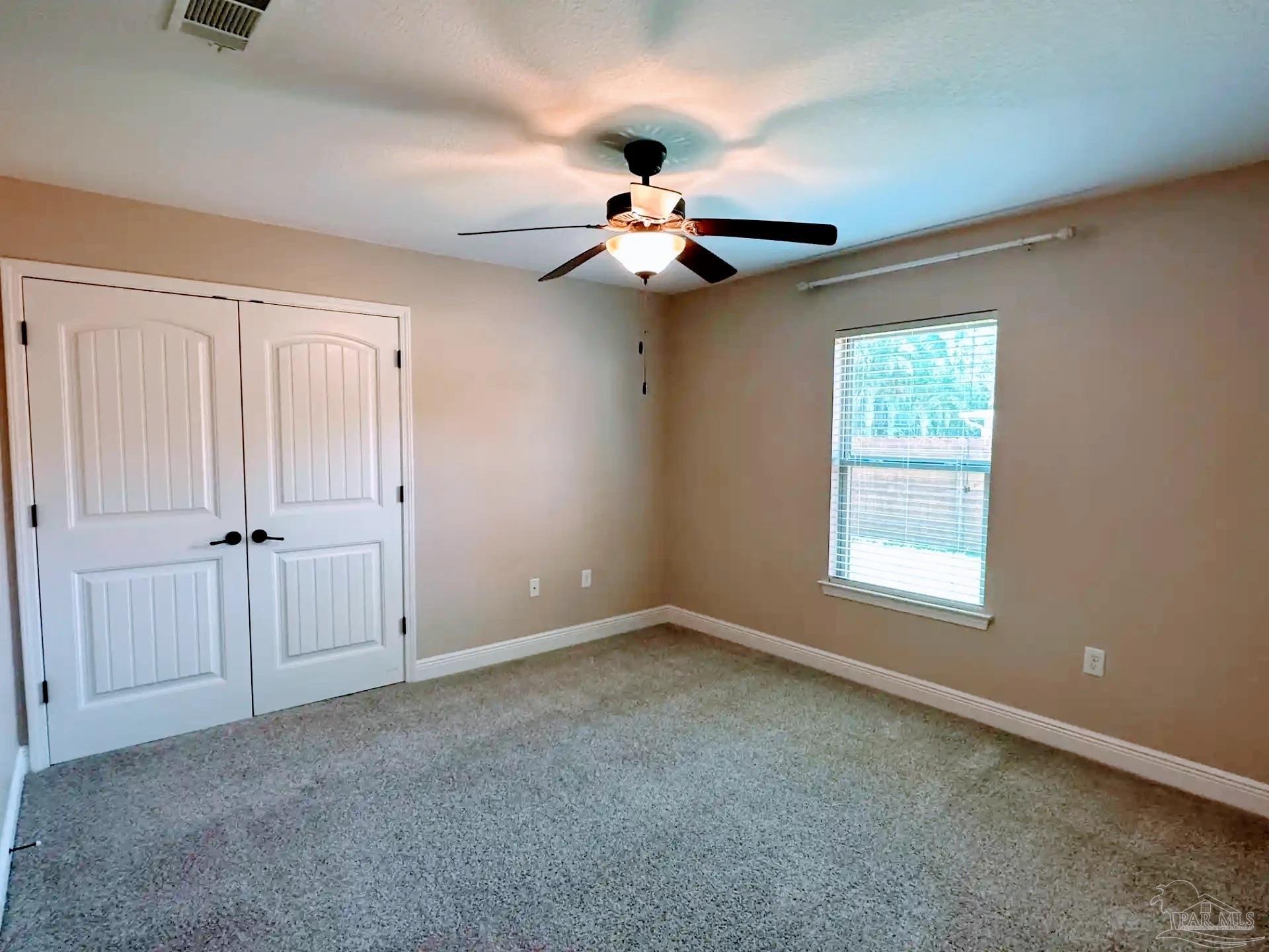 1938 Commodore Drive Navarre, FL 32566 - Photo 17 of 24 a view of an empty room with a window