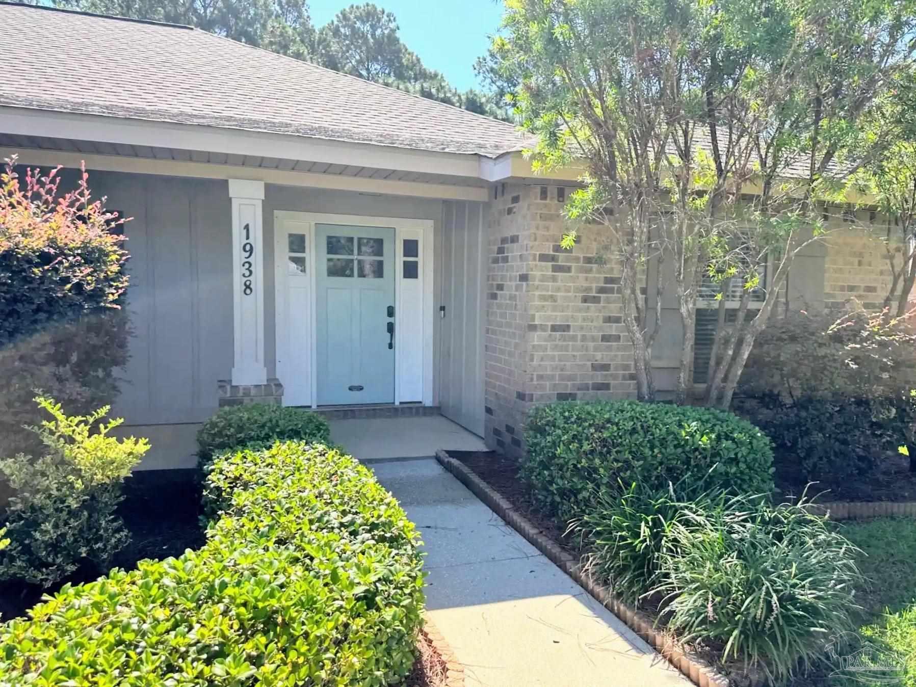 1938 Commodore Drive Navarre, FL 32566 - Photo 2 of 24 a front view of a house with a yard