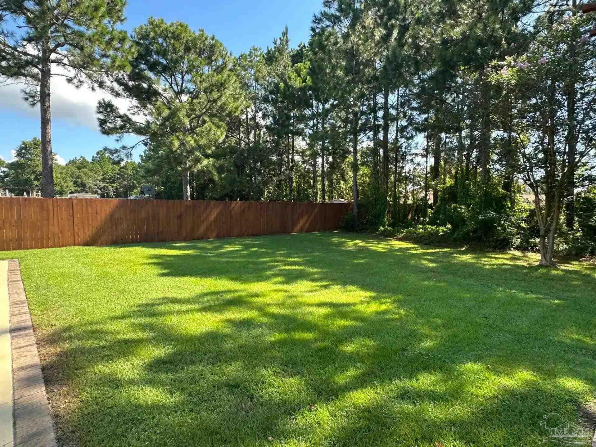 1938 Commodore Drive Navarre, FL 32566 - Photo 21 of 24 a view of swimming pool with a yard