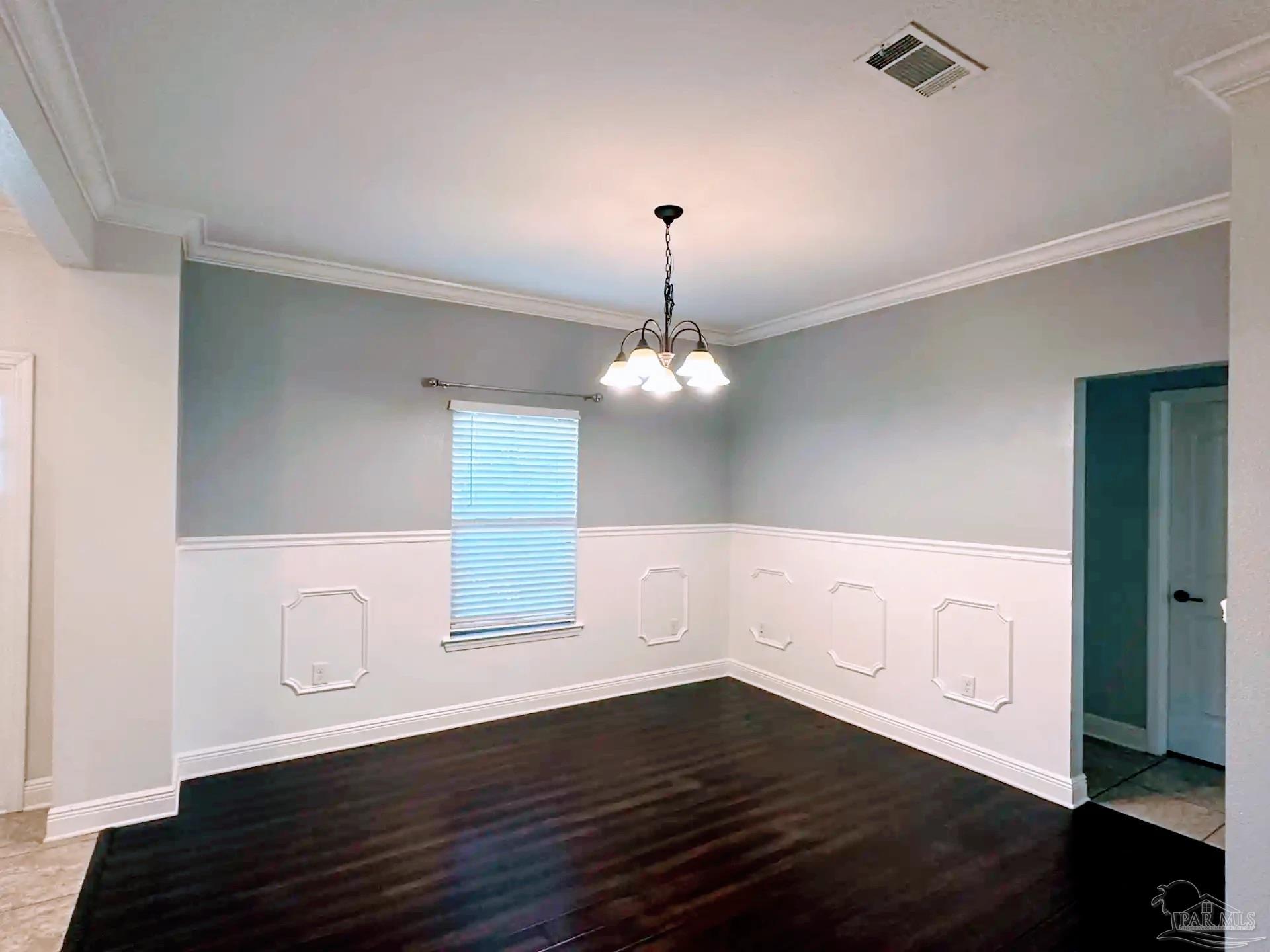 1938 Commodore Drive Navarre, FL 32566 - Photo 6 of 24 a view of an empty room with wooden floor and a window