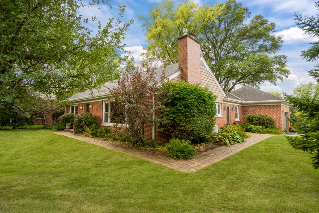 a front view of house with yard and trees