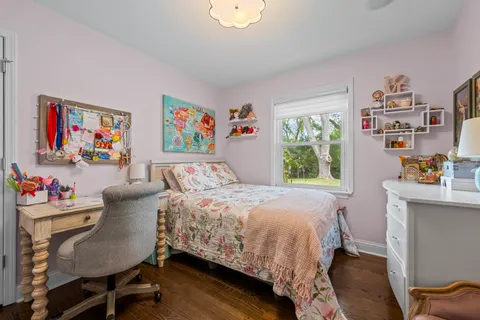 a bedroom with a bed and a bookshelf