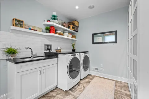 a utility room with sink dryer and washer