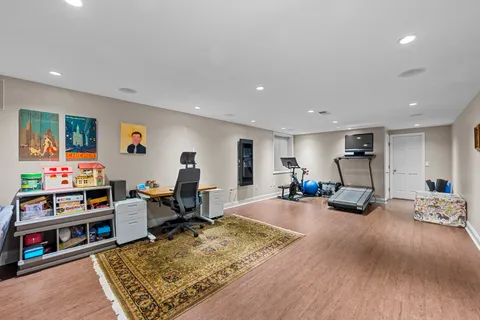 a living room with furniture hard wood floor and a rug