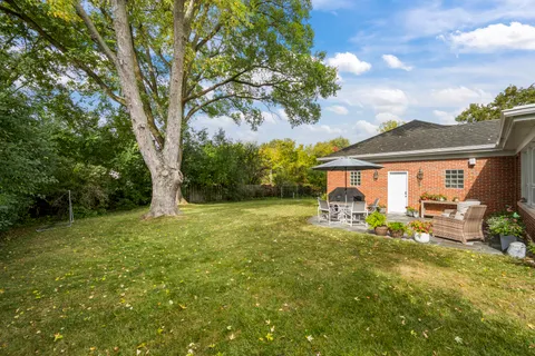 a view of a house with backyard porch and sitting area