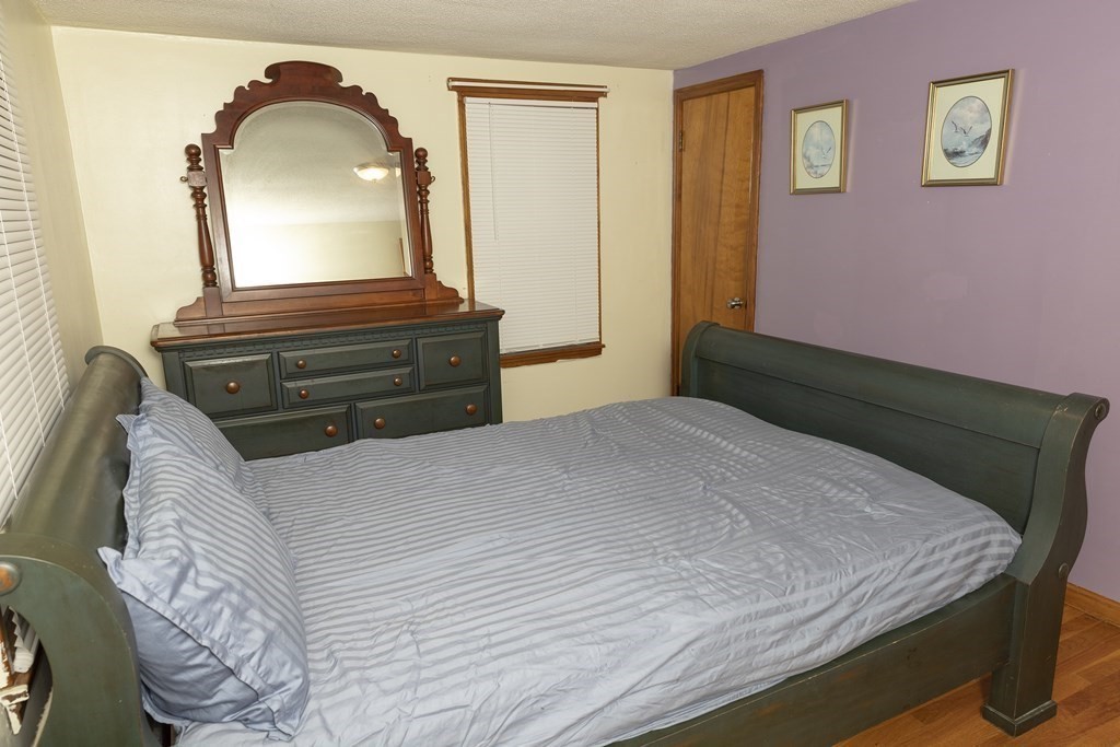 35 Anne Street Springfield, MA 01104 - Photo 11 of 28 a bedroom with a bed and a mirror on dresser