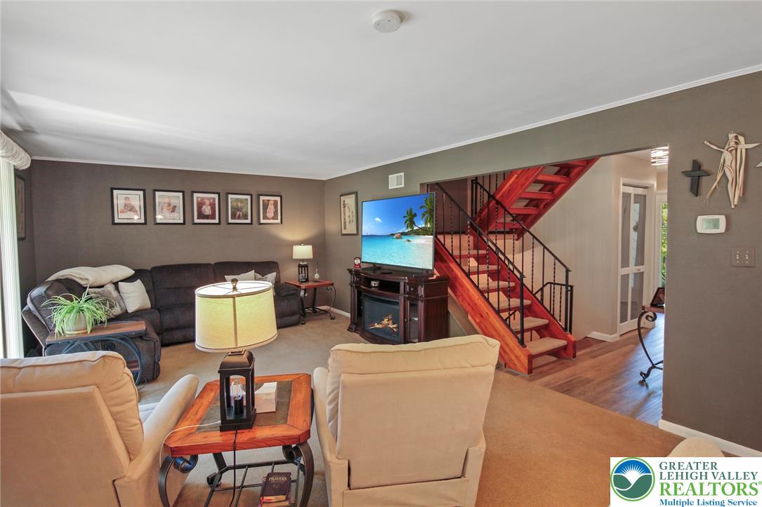 3470 Brodhead Road Bethlehem, PA 18020 - Photo 39 of 84 A striking wooden staircase with intricate wrought iron railings anchors this welcoming living area.