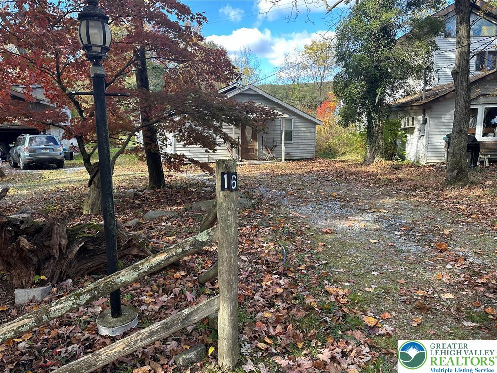 a tree in front of a white house
