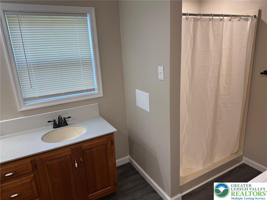 16 Grove Road Northampton, PA 18067 - Photo 9 of 11 a bathroom with a sink a mirror and a window