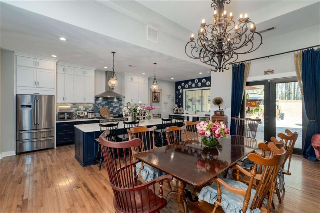 1953-1 Barton Brg Road Madison, GA 30650 - Photo 21 of 78 a view of a dining room with furniture a chandelier and wooden floor