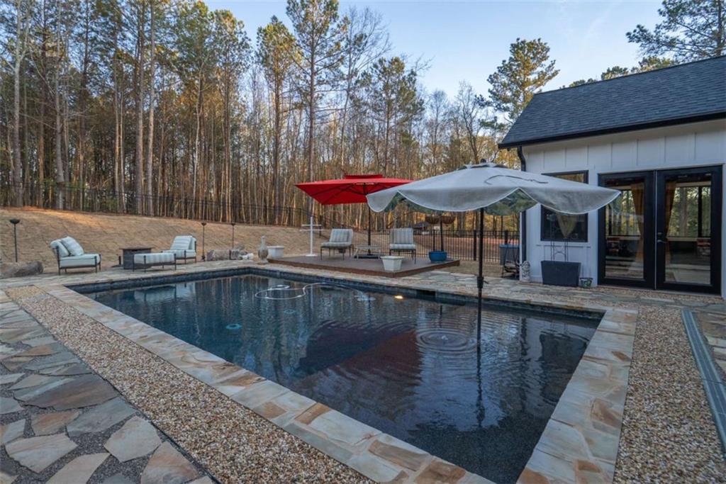 1953-1 Barton Brg Road Madison, GA 30650 - Photo 70 of 78 a view of a patio with chairs and umbrellas on a patio