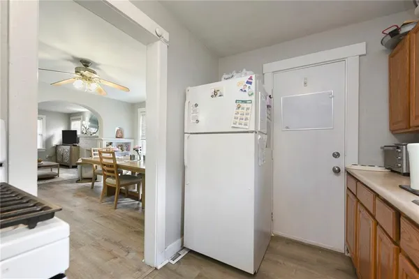 a kitchen with refrigerator and cabinets