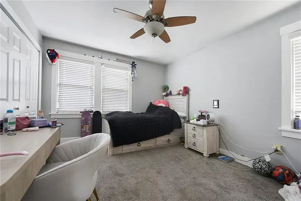 a bedroom with a bed and a couch