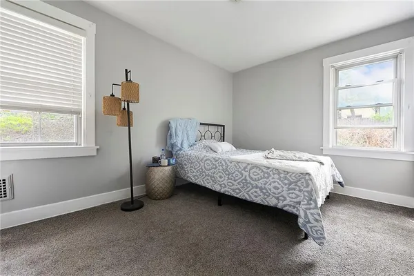 a bedroom with a bed and window
