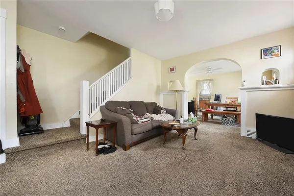 a living room with furniture and a fireplace