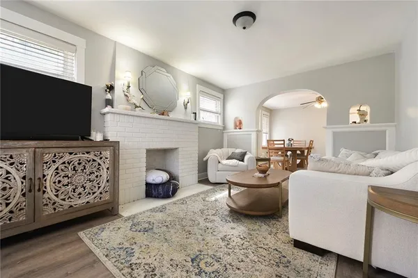 a living room with furniture a flat screen tv and a fireplace