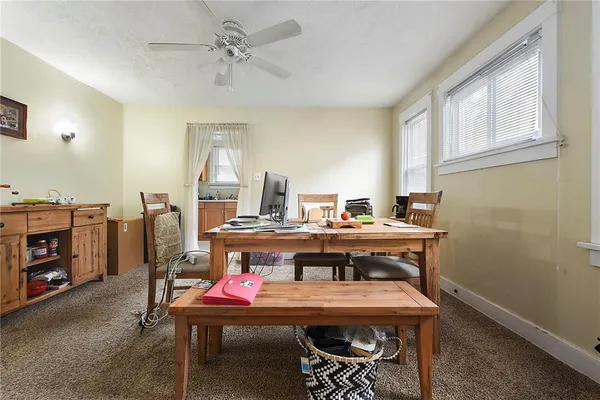 a room with a table chairs and entryway