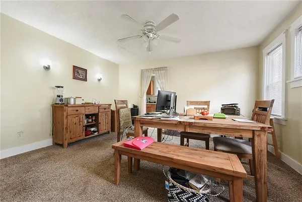 a room with a table chairs and a workspace