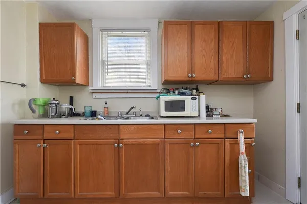 a kitchen with stainless steel appliances granite countertop a sink cabinets and a window
