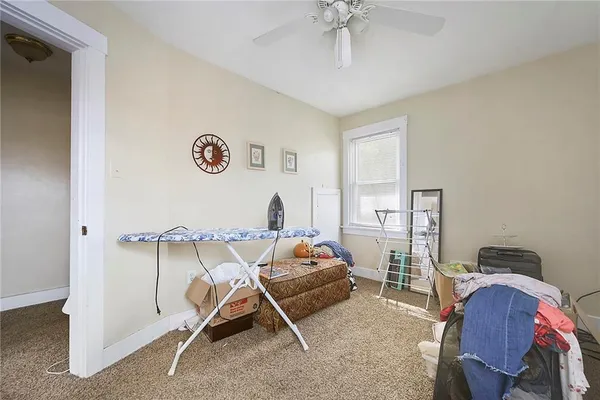 a bedroom with furniture and a window