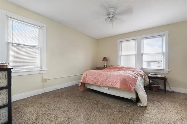 a spacious bedroom with a bed and a window