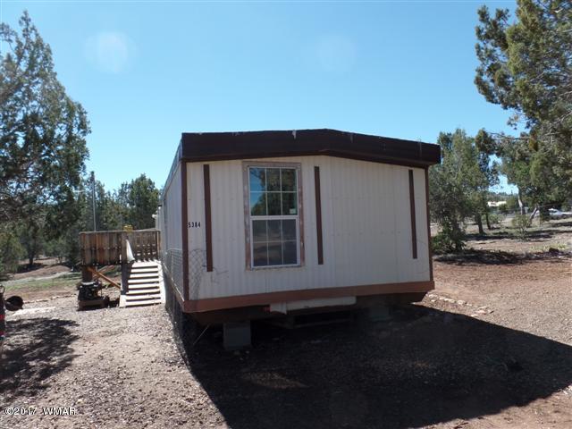 5384 Highway 260 Show Low, AZ 85901 - Photo 1 of 13 a front view of a house with a yard