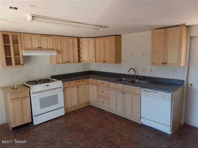 5384 Highway 260 Show Low, AZ 85901 - Photo 4 of 13 a kitchen with granite countertop white cabinets and white appliances