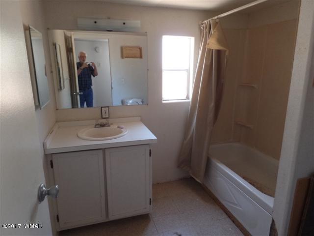 5384 Highway 260 Show Low, AZ 85901 - Photo 6 of 13 a bathroom with a sink a mirror and a bathtub
