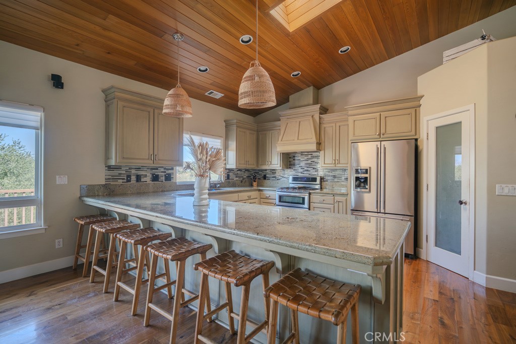 755 Willow Road Nipomo, CA 93444 - Photo 22 of 43 Large breakfast bar peninsula with custom counter tops and kitchen cabinets. Stainless steel appliances and nice walk in pantry.