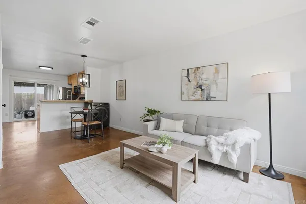 a living room with furniture and wooden floor