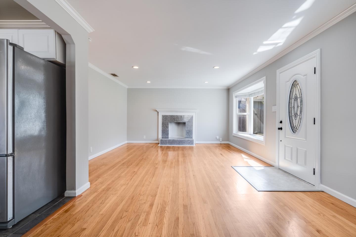 1419 Madeira Drive Pacifica, CA 94044 - Photo 15 of 66 a view of an empty room with wooden floor and a window