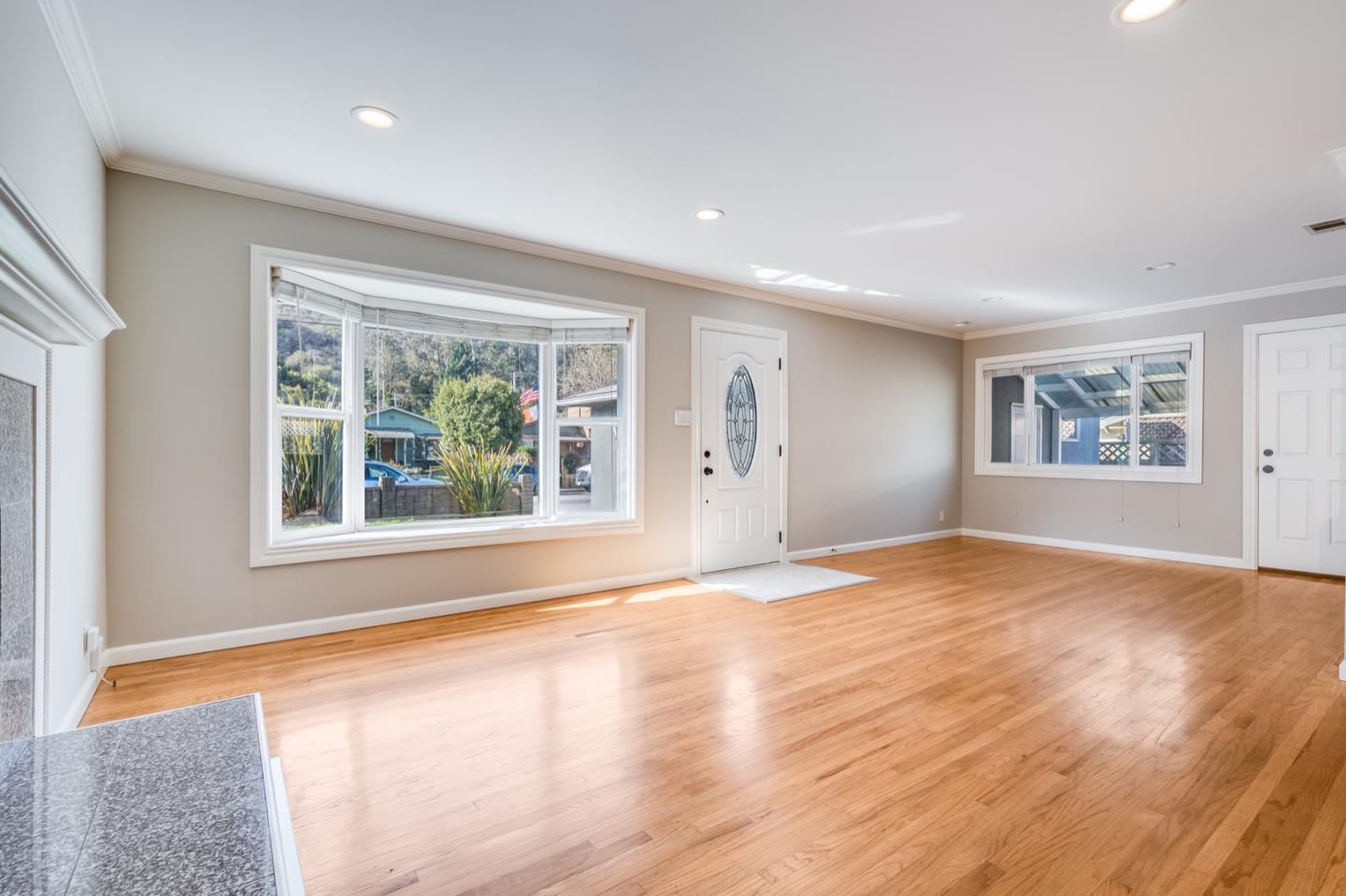 1419 Madeira Drive Pacifica, CA 94044 - Photo 18 of 66 a view of an empty room with a window and wooden floor
