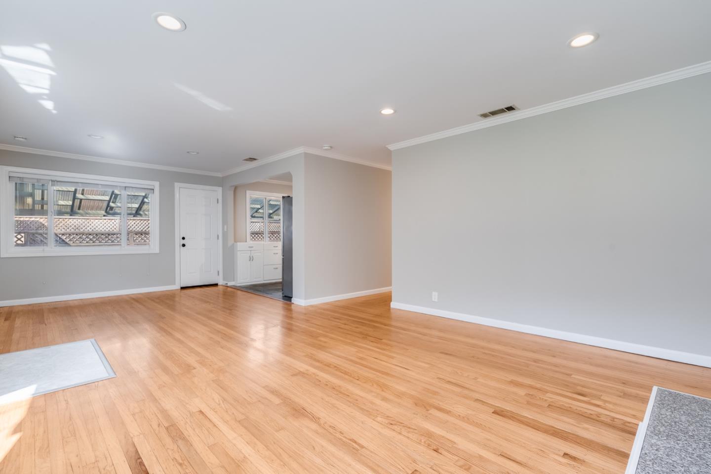 1419 Madeira Drive Pacifica, CA 94044 - Photo 19 of 66 a view of an empty room with wooden floor and a window