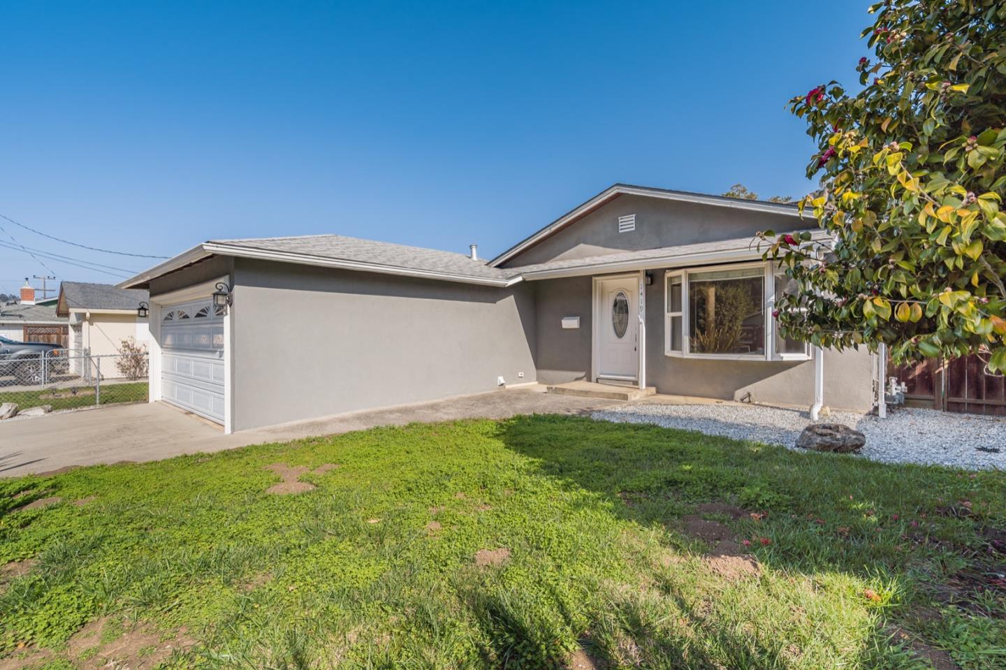 1419 Madeira Drive Pacifica, CA 94044 - Photo 2 of 66 a front view of a house with a yard and garage