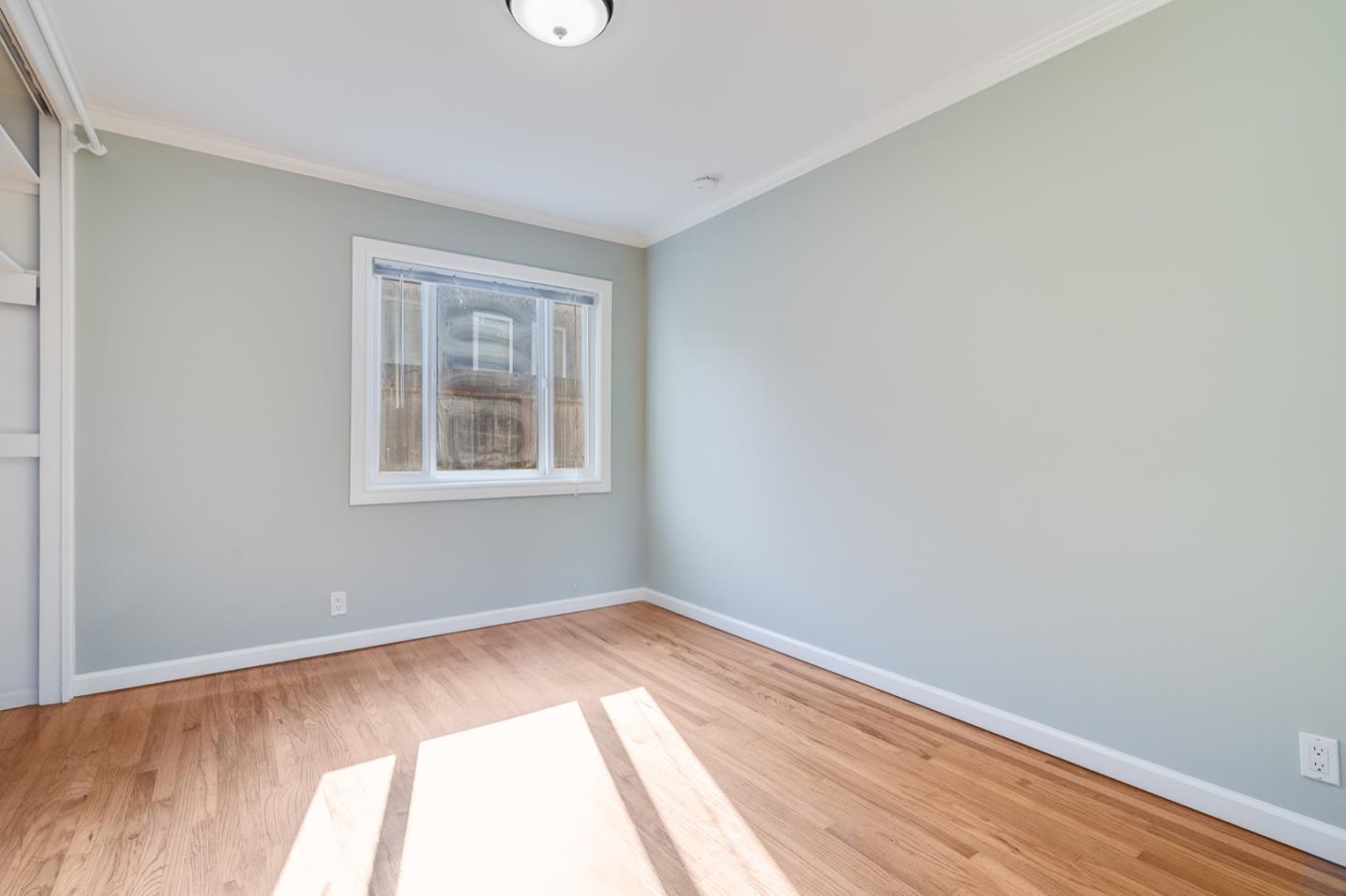 1419 Madeira Drive Pacifica, CA 94044 - Photo 26 of 66 a view of a room with wooden floor and windows