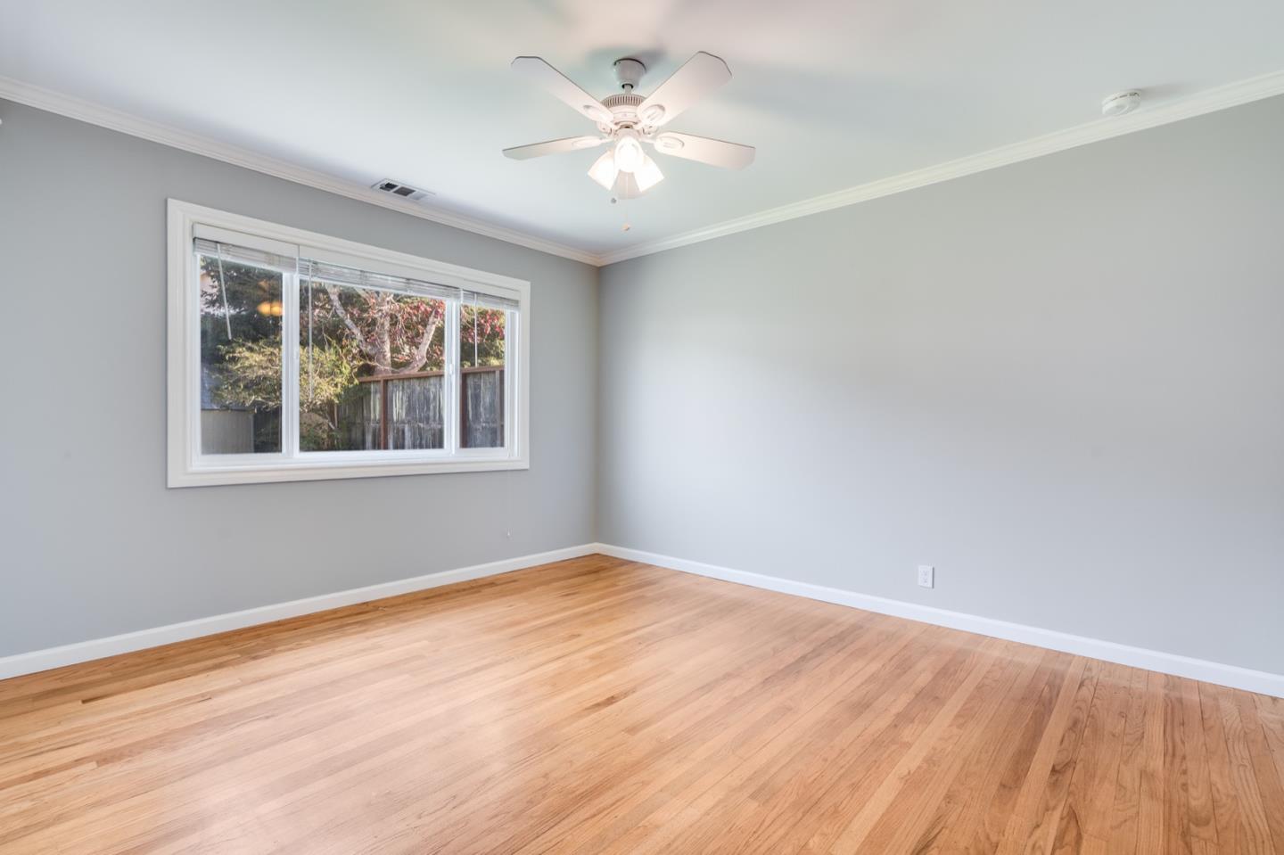 1419 Madeira Drive Pacifica, CA 94044 - Photo 30 of 66 a view of empty room with wooden floor and fan